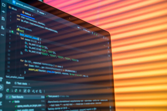 Green code and system status lines on a dark monitor